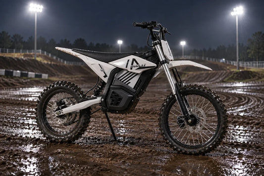 MUDLIZ electric dirt bike on a floodlit wet practice track