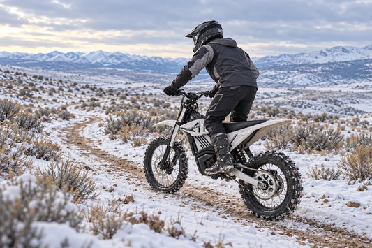 MUDLIZ electric dirt bike riding on a lightly snow-covered trail