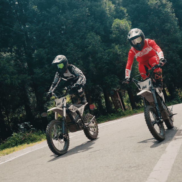 Two riders on Mudliz electric dirt bikes