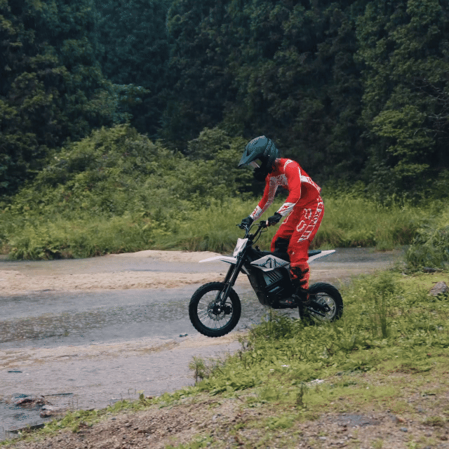 Rider in red on a Mudliz electric dirt bike